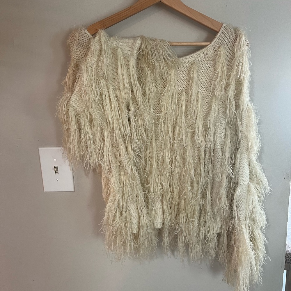 Light weight sweater with tinsel like airy fabric.
